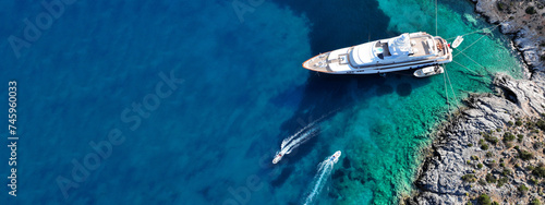 Obraz na płótnie Aerial drone ultra wide top down photo with copy space of luxury yacht anchored in tropical exotic island with crystal clear turquoise sea w salonie