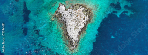 Aerial drone ultra wide photo of secluded heart shaped island with turquoise sea in Caribbean exotic destination