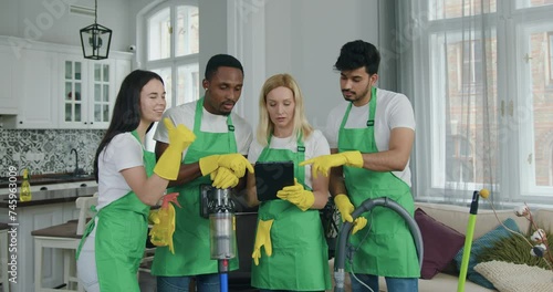 Woman from cleaning service giving commands to each member of her team people when they came to clean up customer house photo