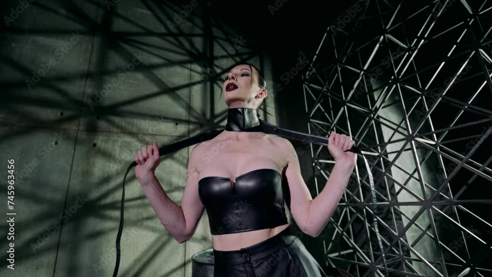 sexy lady in black leather suit strangling herself in dark basement, bdsm dominatrix woman sexy lady in black leather suit strangling herself in dark basement, bdsm dominatrix woman
