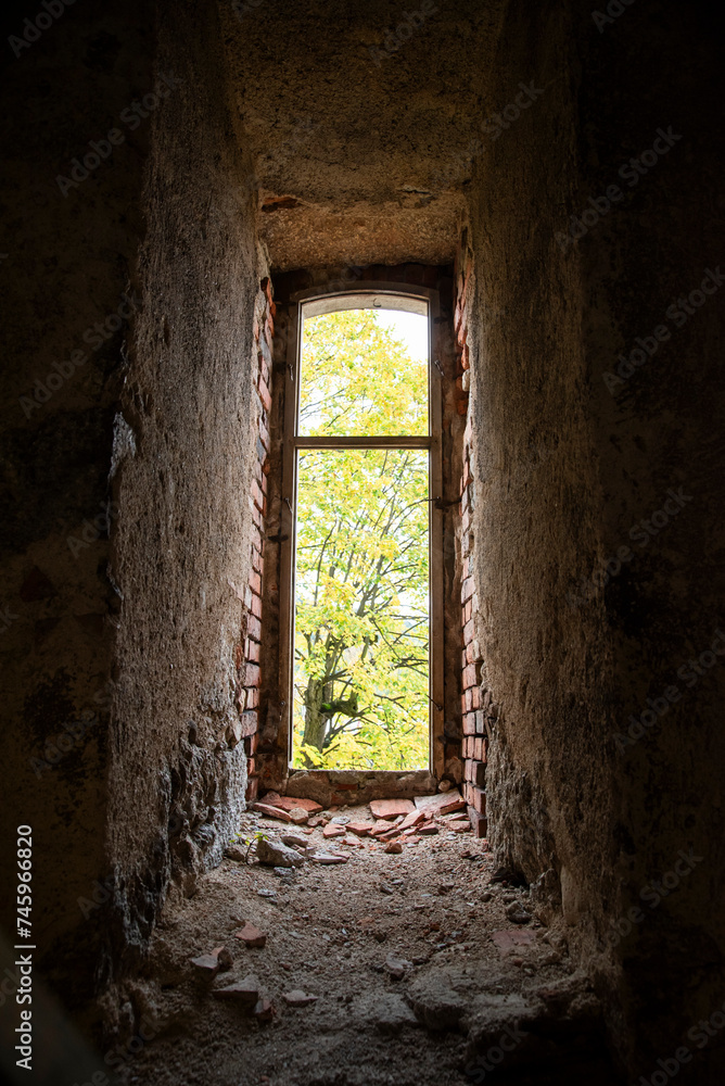 Old window in an abandoned ruined building overlooking the park. Old window in an abandoned ruined building overlooking the park.