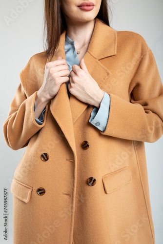 Elegant woman in stylish warm wool coat isolated on white background photo