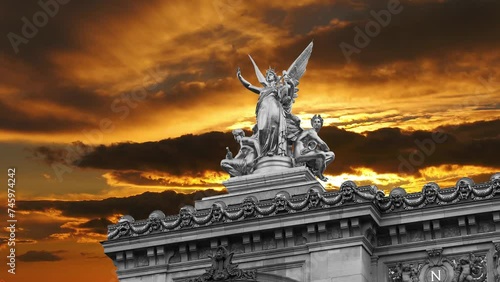 Golden statue of Liberty on the roof of the Opera Garnier (Garnier Palace)  against the background of the sunset. Sculpted by Charles Gumery in 1869. Paris, France. 4K, time lapse   photo