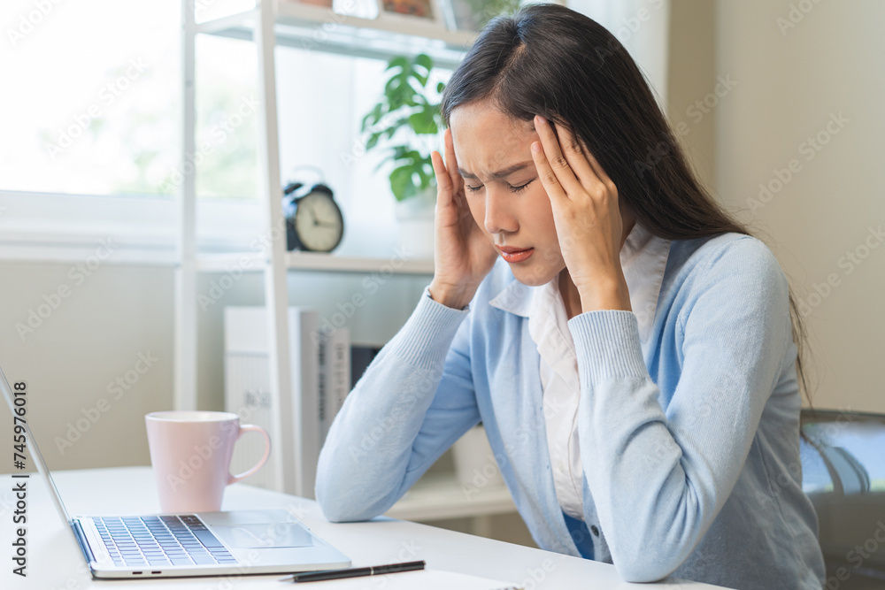 Stressed, exhausted asian young woman, girl pain from vertigo, having migraine symptoms headache, feel unhealthy, suffering from dizziness, holding head with hand. Health care problem of people. Stressed, exhausted asian young woman, girl pain from vertigo, having migraine symptoms headache, feel unhealthy, suffering from dizziness, holding head with hand. Health care problem of people.