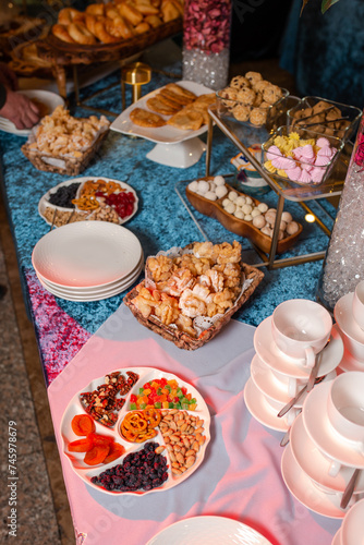 top view of Kazakhstani treats. Delicious pastries and nuts on a blue velvet tablecloth.