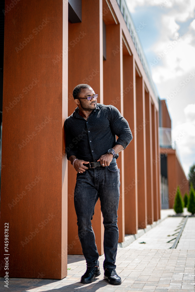Young handsome man walks around the city and poses for the camera. stylish man walks through the city stylish man is walking around the town Young handsome man walks around the city and poses for the camera. stylish man walks through the city stylish man is walking around the town