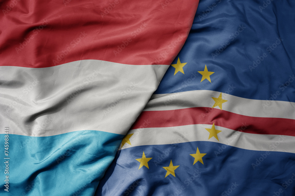 big waving national colorful flag of cape verde and national flag of luxembourg . big waving national colorful flag of cape verde and national flag of luxembourg .