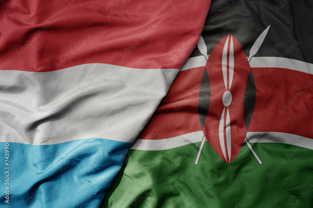 big waving national colorful flag of kenya and national flag of luxembourg .