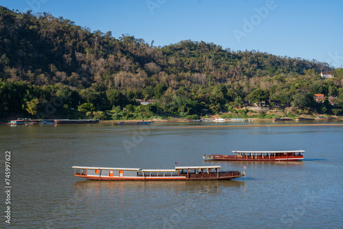 Laotian wooden boats on the Mekong River in Luang Prabang in Laos Southeast Asia
