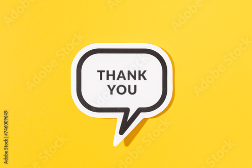 Thank you text on speech bubble isolated on yellow background