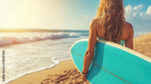 Closeup portrait of a female surfer holding surfboard on the ocean cost © GulArt