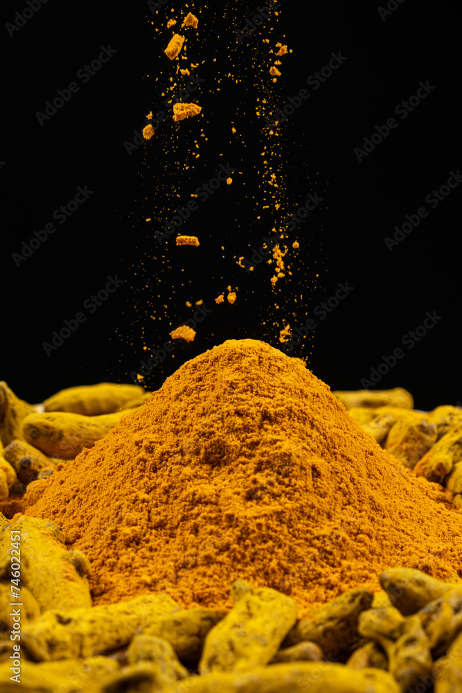 Turmeric powder sprinkled on the dry turmeric root Turmeric powder sprinkled on the dry turmeric root