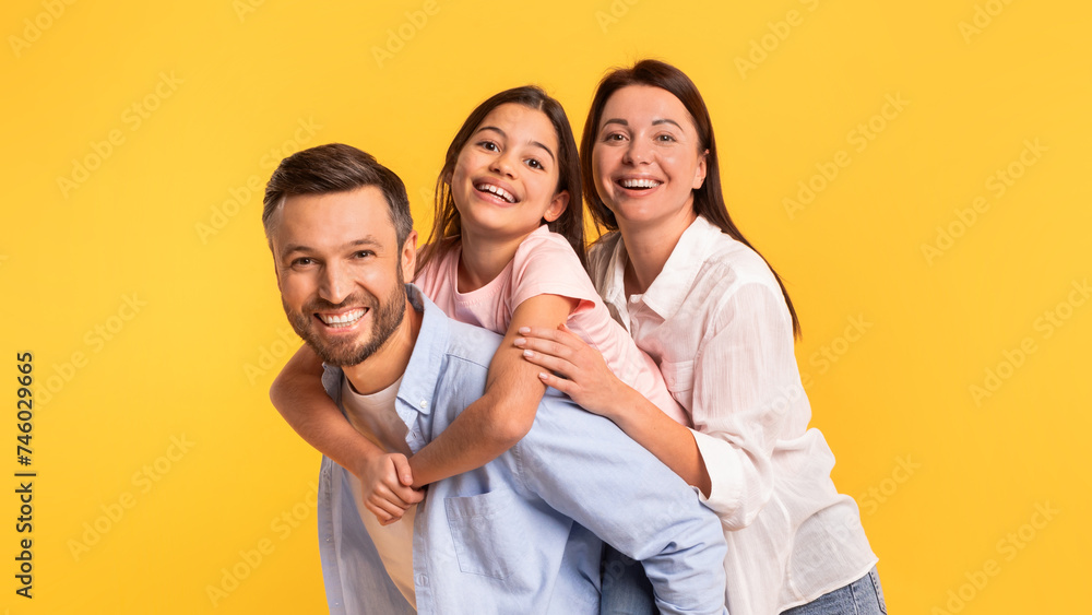 Family portrait of joyful parents and their daughter girl embracing Family portrait of joyful parents and their daughter girl embracing