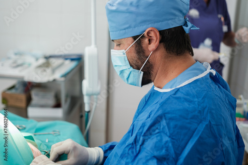 Young man doing surgery in operating room with everything sterilized to avoid infections