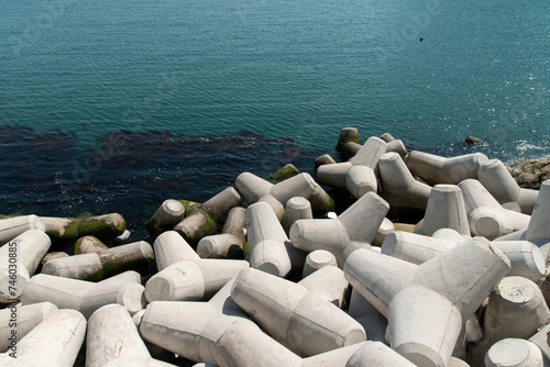 High-angle view of the sea with tetrapods and seaweed