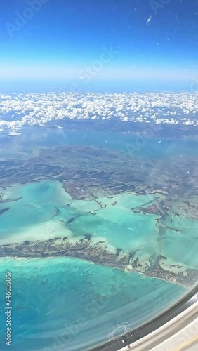 Aerial view of the Caribbean islands from the airplane window. Airplane wing fly over tropical island. View from the plane window of emotional moment during international travel around the world.