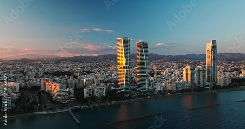 Majestic Sunset Over Limassol, Cyprus. Aerial Perspectives of Limassol's Modern Urban Landscape with High-Rise Glass Structures.