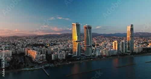 Majestic Sunset Over Limassol, Cyprus. Aerial Perspectives of Limassol's Modern Urban Landscape with High-Rise Glass Structures. photo