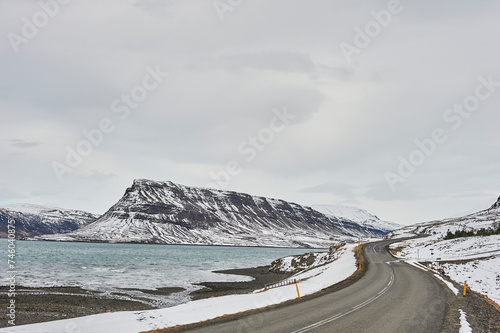 Northern landscapes: A scenic route curving around the snowy mountains of Hvalfjörður fjord.