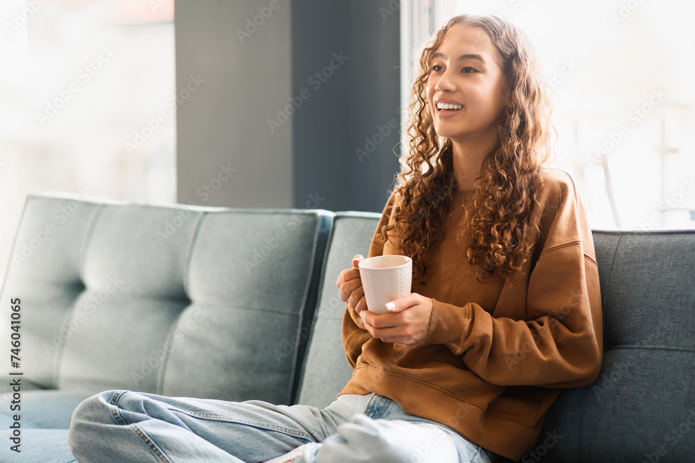 girl enjoys weekend sitting with warm cup of tea indoors girl enjoys weekend sitting with warm cup of tea indoors