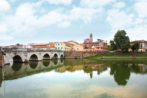 Historical roman Tiberius Bridge over Marecchia river in Rimini, Italy photo