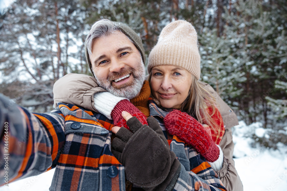 Mature couple looking happy and making selfie