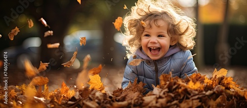 Joyful Kid Having Fun Playing in Colorful Autumn Leaves During School Break