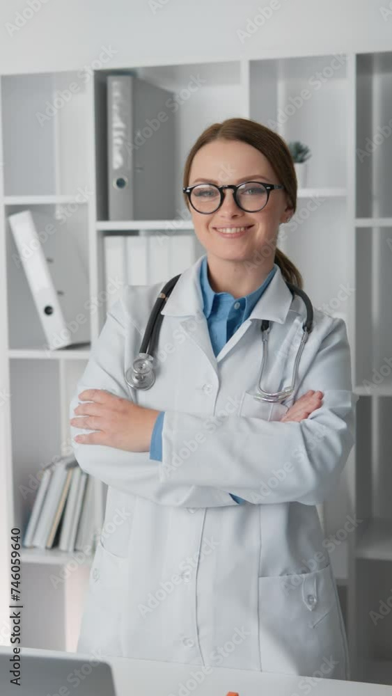 In this vertical video, a doctor in her office poses confidently for the camera, demonstrating professional elegance and self-confidence. Her posture reflects the strength and trust that she will In this vertical video, a doctor in her office poses confidently for the camera, demonstrating professional elegance and self-confidence. Her posture reflects the strength and trust that she will