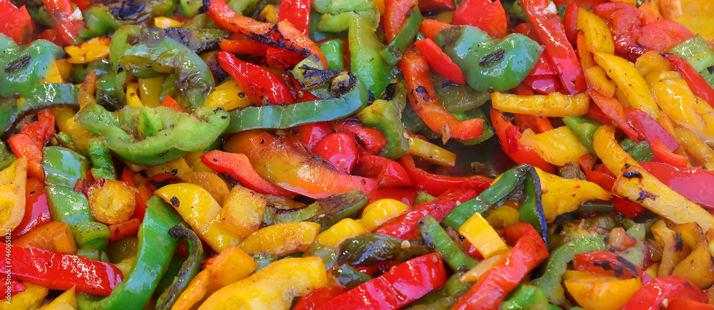 background of Red green and yellow peppers seasoned with oil