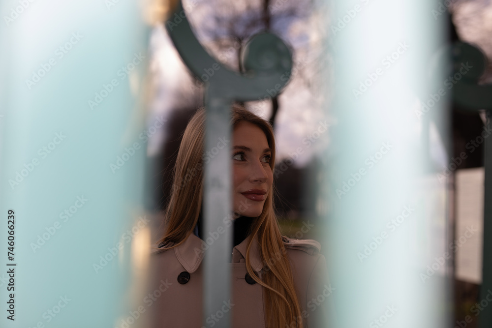 Fototapeta premium wunderful sporty woman with blond hair well dressed in park at first sunshine of a year