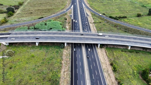An overhead perspective of a highway featuring two lanes for vehicles to travel. The road stretches into the distance, with cars and trucks moving in different directions.