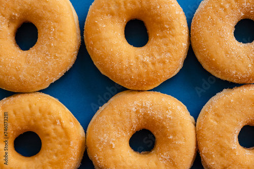 six doughnuts on blue background photo