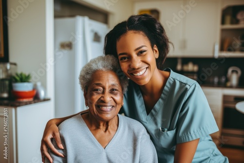 Portrait of a young female caregiver with senior patient at home photo