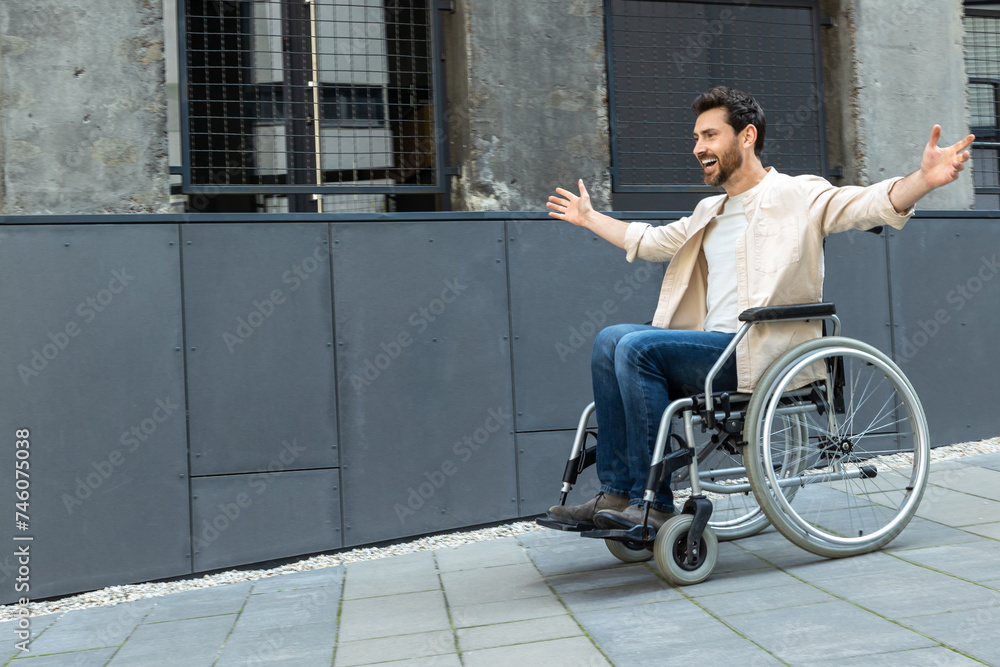 Obraz premium Young man on a wheelchair feeling free and excited