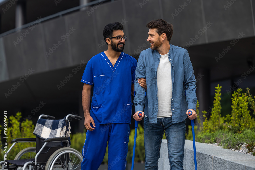 Male nurse helping a patient with disability Male nurse helping a patient with disability