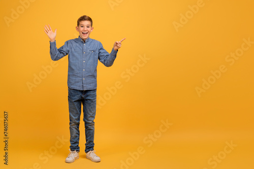 Happy Excited Teen Boy Pointing Aside At Copy Space With Finger