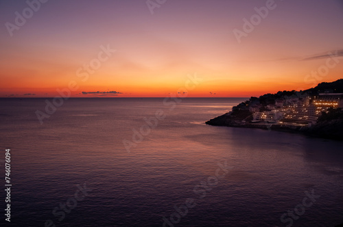 Sunset in Dubrovnik with a view of the buildings, calm sea during sunset, sunset colors © DUOTONE