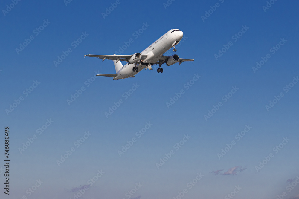 Airplane taking off from the airport. White Passenger plane fly up over runway from airport. Commercial passenger airplane takes off from the runway. Airplane taking off from the airport. White Passenger plane fly up over runway from airport. Commercial passenger airplane takes off from the runway.