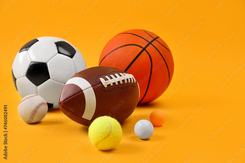 Many different sports balls on yellow background, space for text