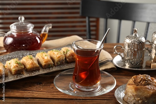 Turkish tea and sweets served in vintage tea set on wooden table