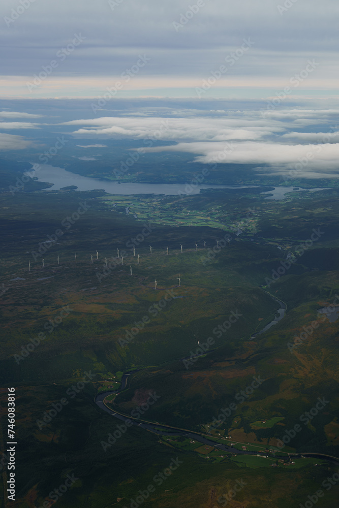 Beautiful aerial view of Norway with a Fjord and wind turbinesin the background