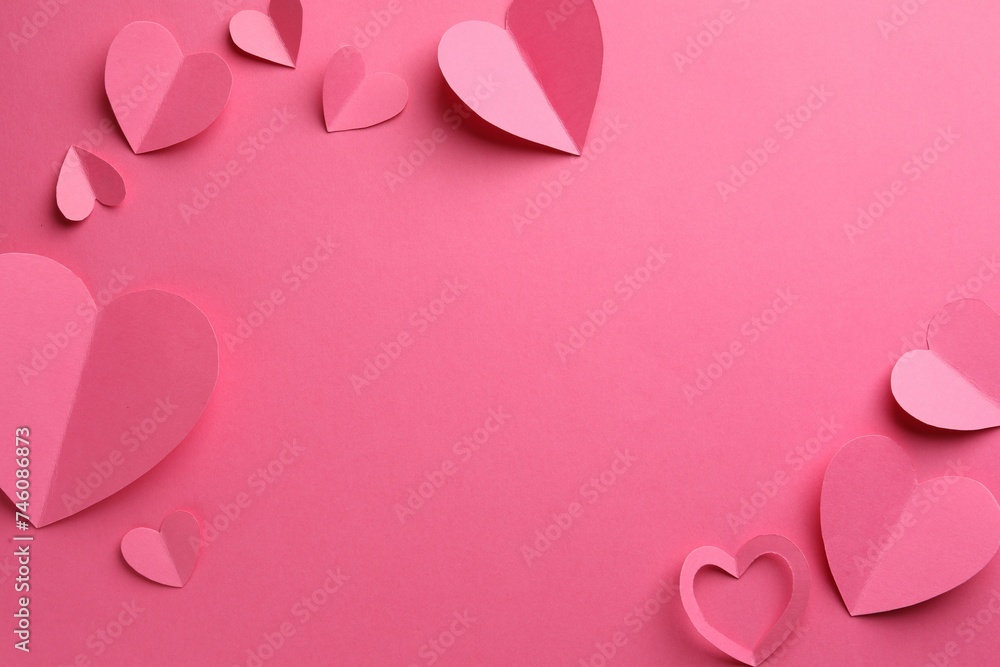 Paper hearts on pink background, flat lay. Space for text