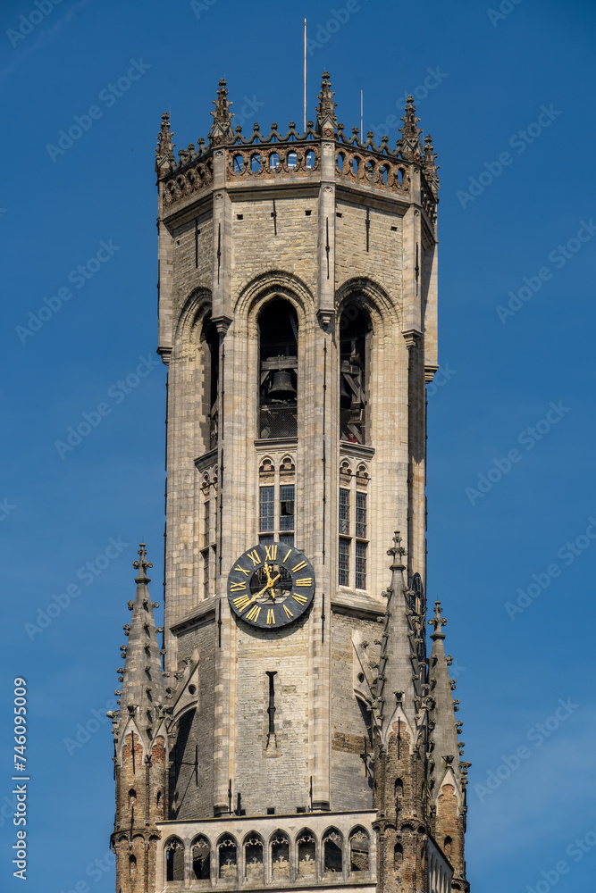 Beautiful close-up on the head of the Belfry of Bruges during a sunny day