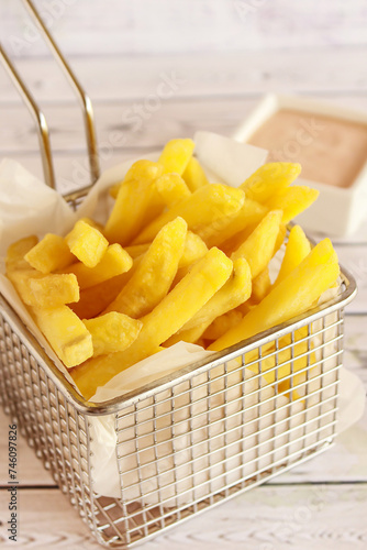 FRENCH FRIES Bucket Closeup served in dish isolated on table side view of arabic fastfood