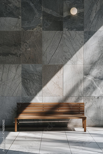 Wooden bench in front of a gray tile wall.