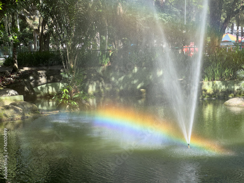 Rainbow over the lake water surface in the park in Icarai, Niteroi, Rio de Janeiro, Brazil © Isbel Dias