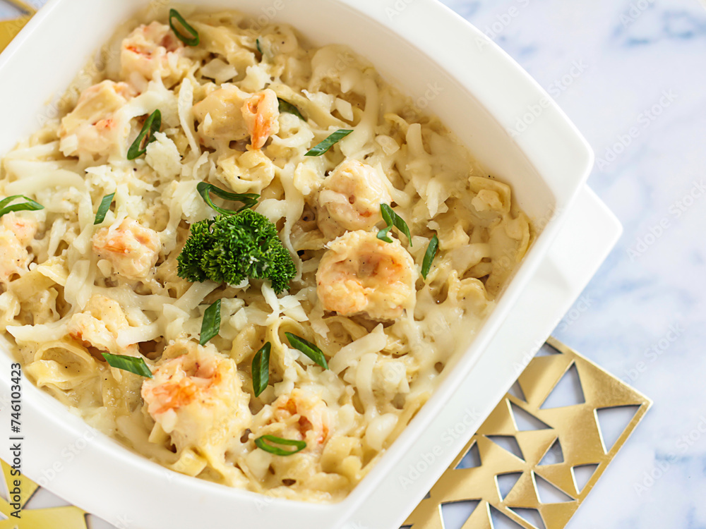 SHRIMPS FETTUCCINE with Cream Sauce Served in dish isolated on table closeup top view of italian food SHRIMPS FETTUCCINE with Cream Sauce Served in dish isolated on table closeup top view of italian food