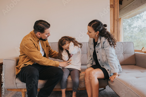 Child covering her ears while her parents are talking