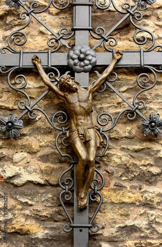 A metal crucifix on a church wall. Catholic symbol