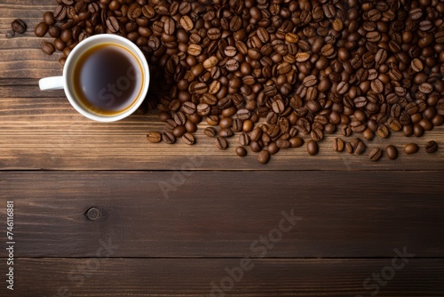 Cup of coffee with coffee beans on a wooden background - Top view